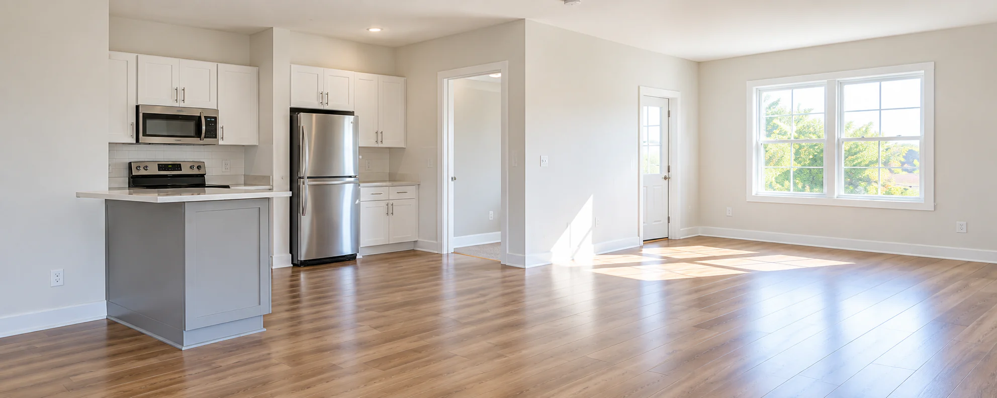 Empty rental unit kitchen and living room prepared for the next tenant